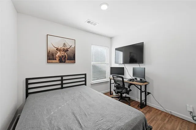 a bedroom with a workspace