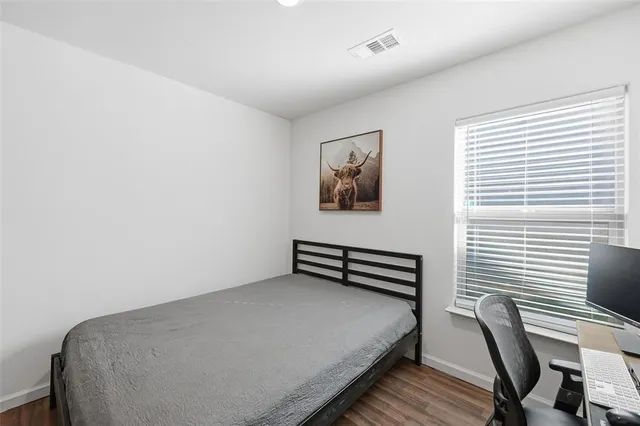 a bedroom with a bed and a workspace