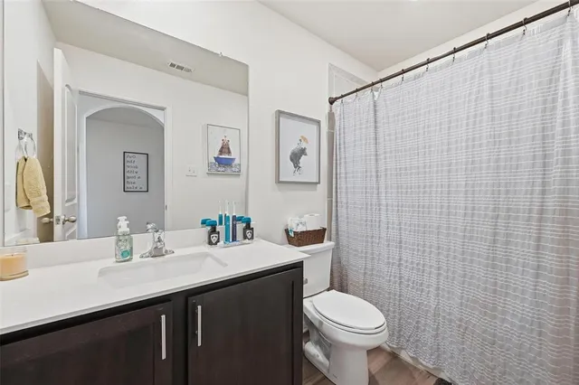 a bathroom with a sink a toilet and a mirror