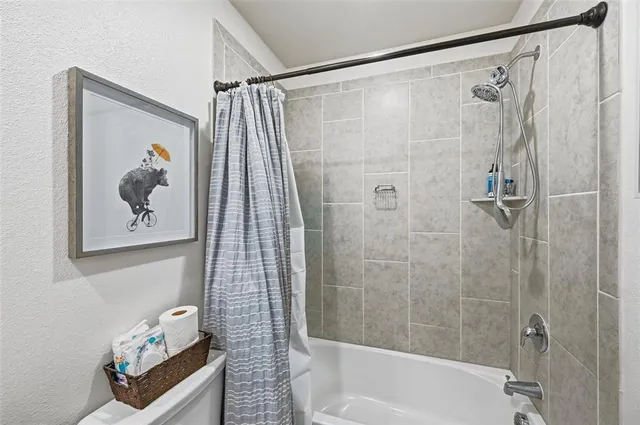 a bathroom with a shower and a bathtub