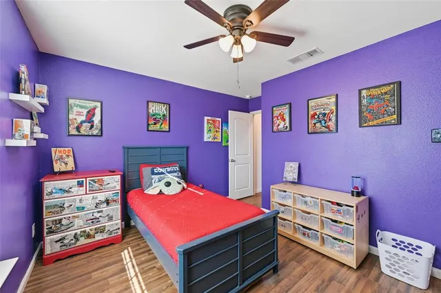 a bedroom with a bed and a dresser