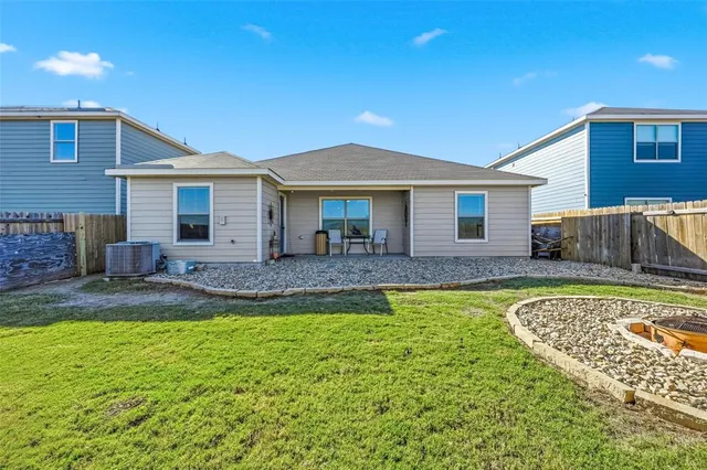 a view of a house with a swimming pool and a yard