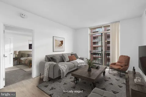 a living room with furniture rug and window