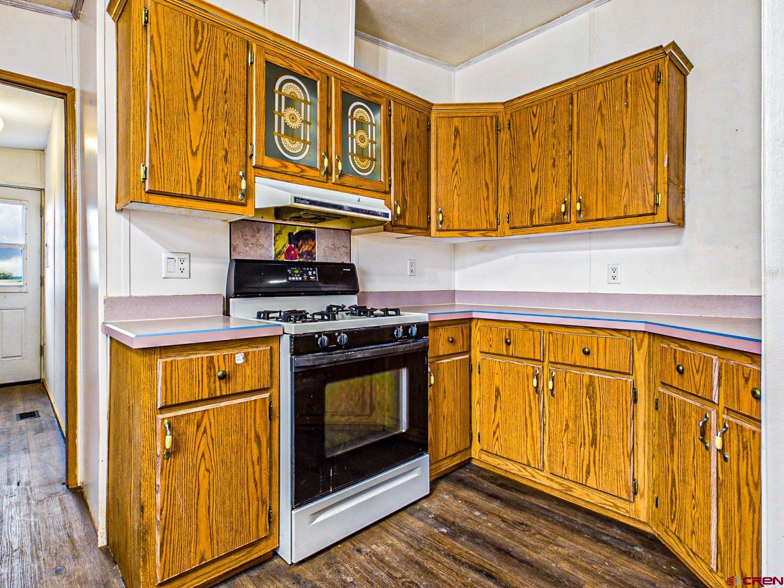 15484 Peach Road Cedaredge, CO 81413 - Photo 12 of 35 a kitchen with stainless steel appliances granite countertop a stove and a refrigerator