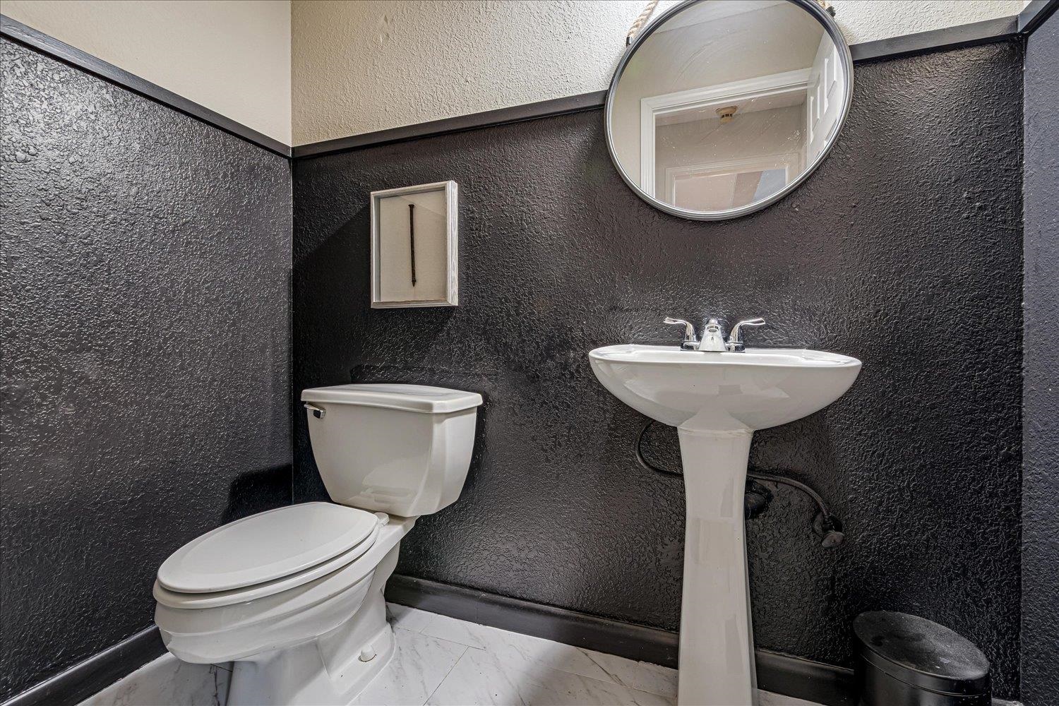 8379 Craven Road Bartlett, TN 38002 - Photo 15 of 40 a bathroom with a toilet sink and mirror