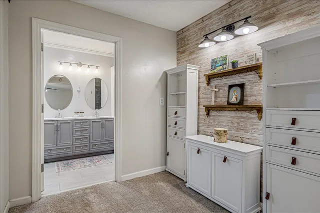 a bathroom with a double vanity sink and mirror