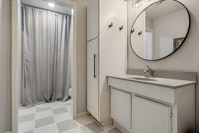 a bathroom with a sink a mirror and a shower