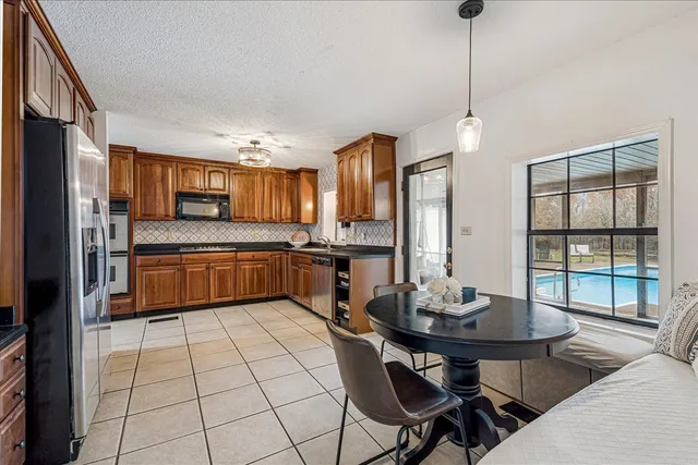 a kitchen with a sink a counter top space stainless steel appliances and cabinets
