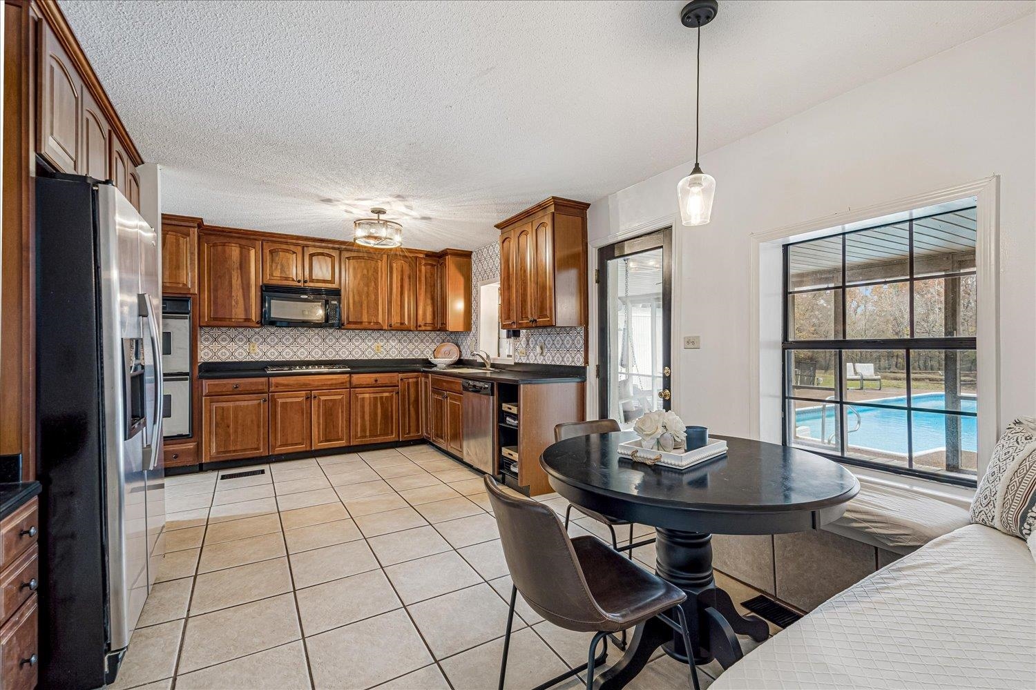 8379 Craven Road Bartlett, TN 38002 - Photo 10 of 40 a kitchen with a sink a counter top space stainless steel appliances and cabinets