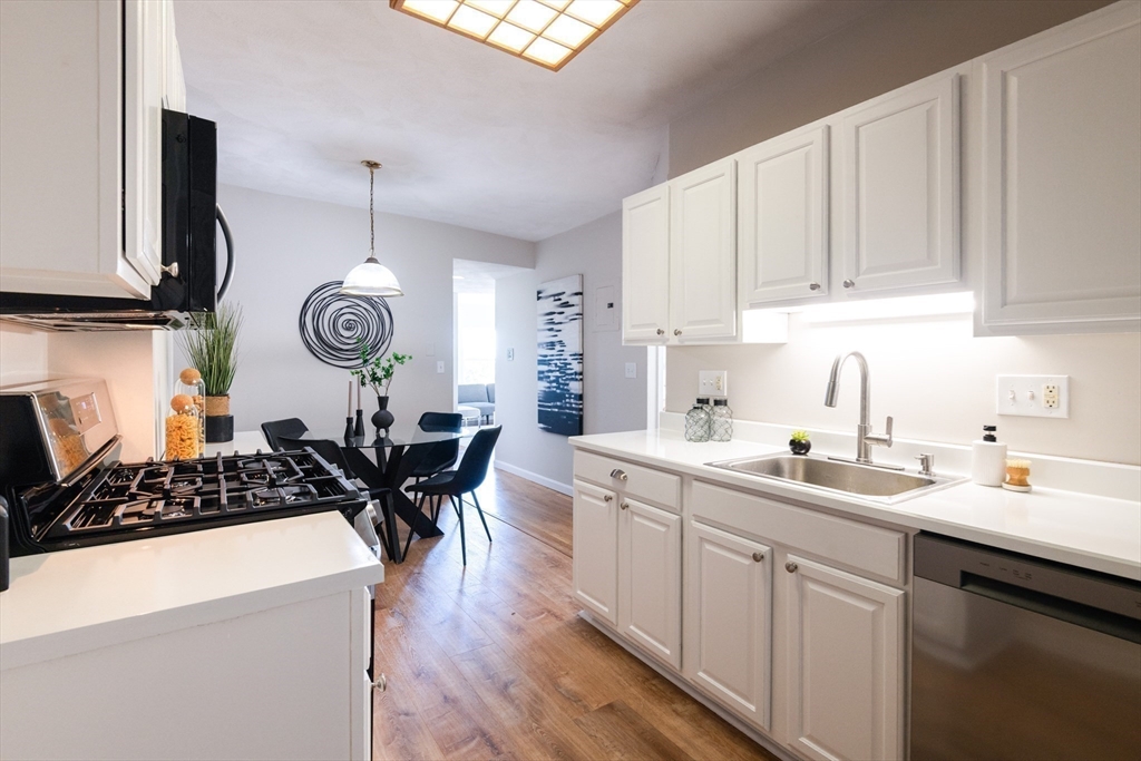 407 Washington Street, Unit 5 Boston, MA 02124 - Photo 1 of 24 a kitchen with a sink a stove and cabinets