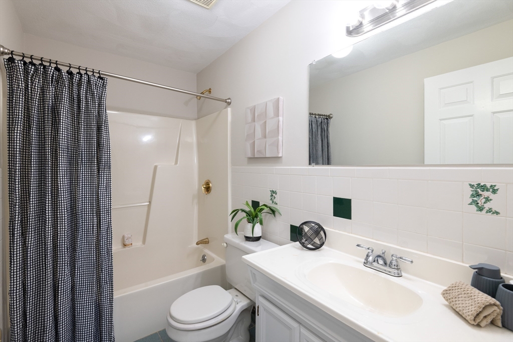407 Washington Street, Unit 5 Boston, MA 02124 - Photo 11 of 24 a bathroom with a sink a toilet and shower