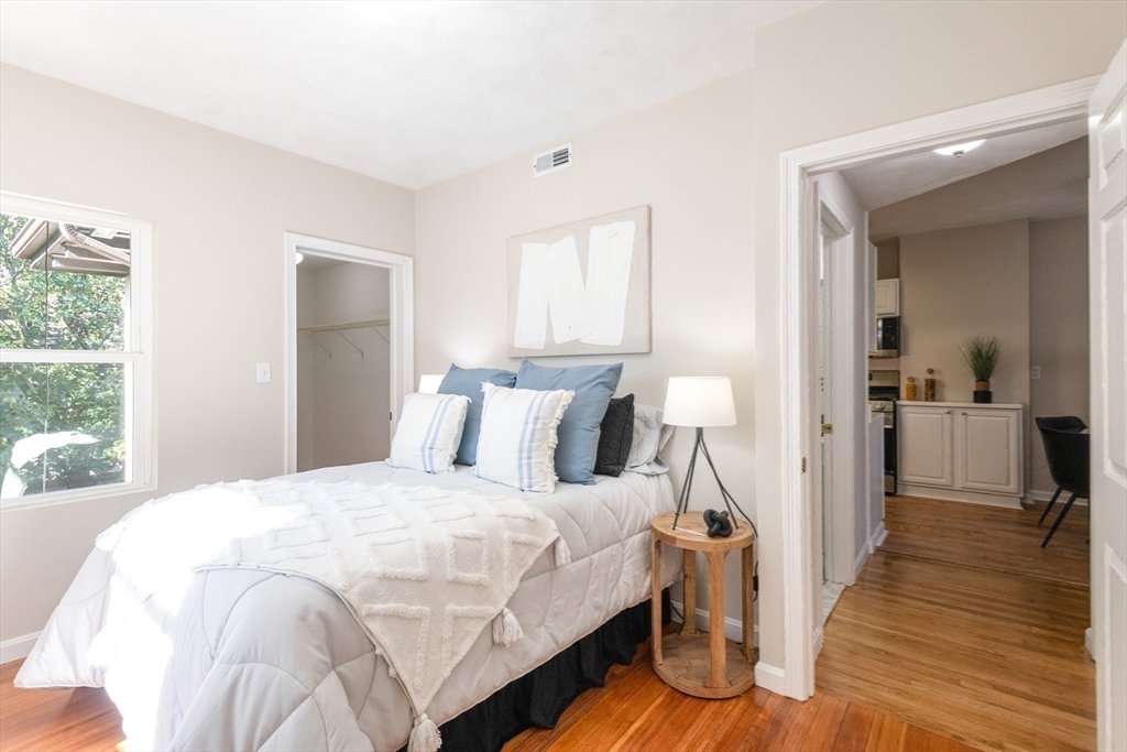 407 Washington Street, Unit 5 Boston, MA 02124 - Photo 18 of 24 a bedroom with a bed and a mirror