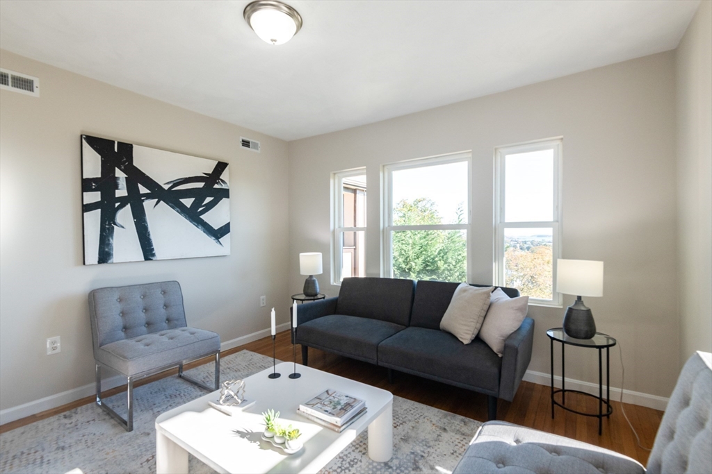 407 Washington Street, Unit 5 Boston, MA 02124 - Photo 4 of 24 a living room with furniture and a large window