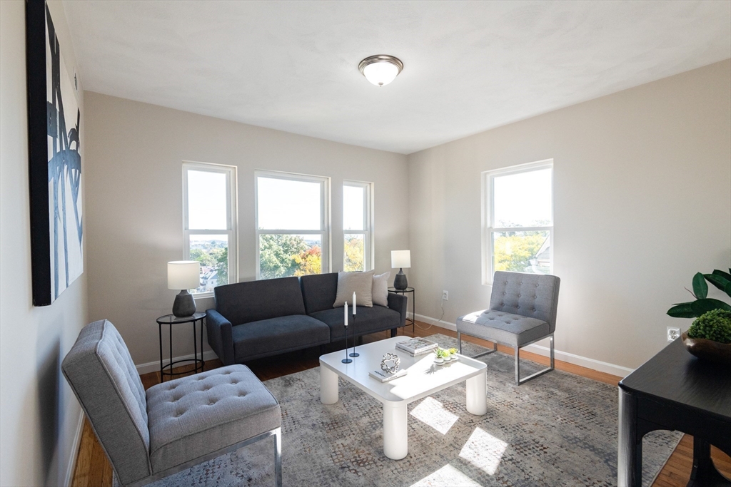 407 Washington Street, Unit 5 Boston, MA 02124 - Photo 5 of 24 a living room with furniture and a window
