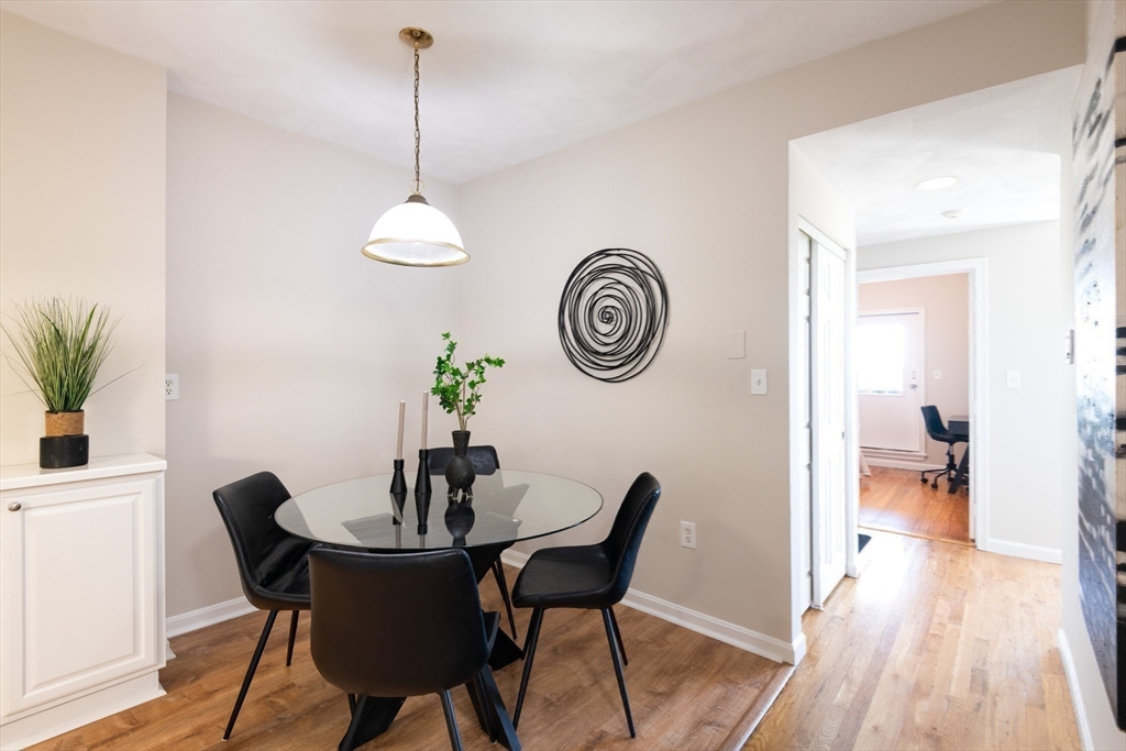 407 Washington Street, Unit 5 Boston, MA 02124 - Photo 8 of 24 a dining room with a table and chairs