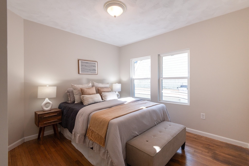 407 Washington Street, Unit 5 Boston, MA 02124 - Photo 9 of 24 a bedroom with a bed and a window