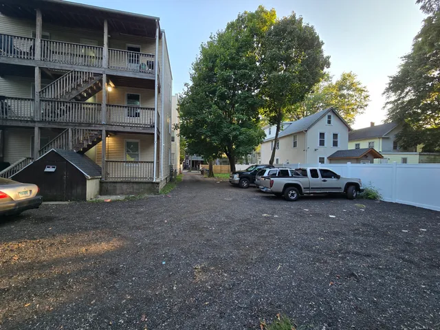 a car parked in front of white house