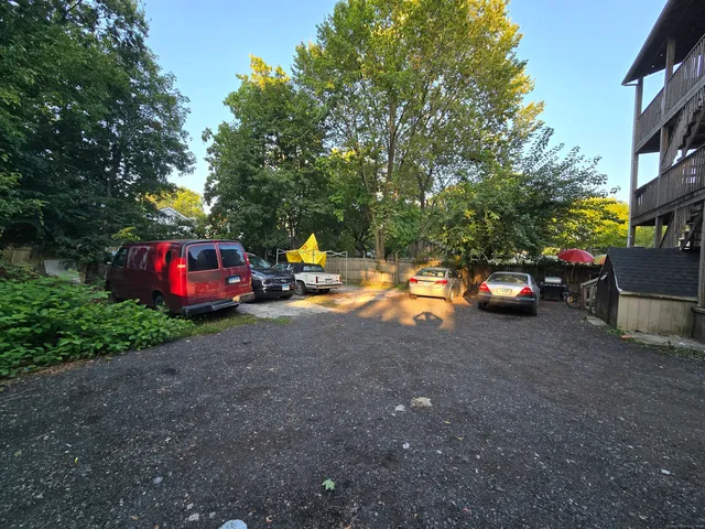 a view of outdoor space with cars parked