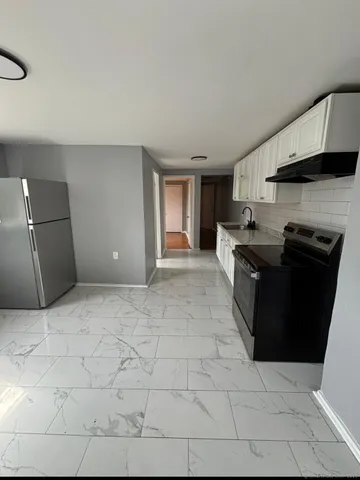 a kitchen with stainless steel appliances granite countertop a sink and a stove