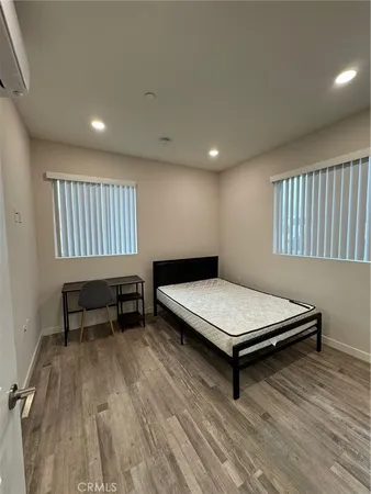 a bedroom with furniture and a wooden floor