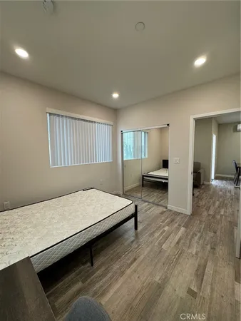 a living room with hard wood floors and furniture