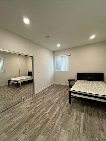 an empty room with wooden floor table and chairs