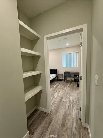 a view of a room with wooden floor closet and windows