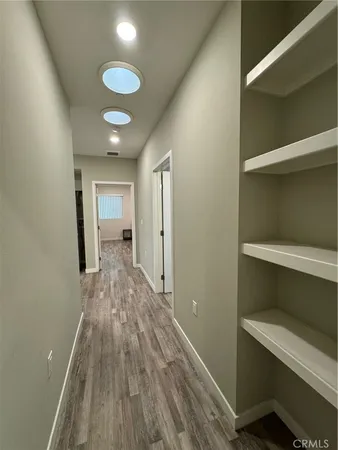 a view of hallway with wooden floor