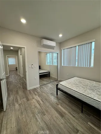 a bedroom with a bed and mirror