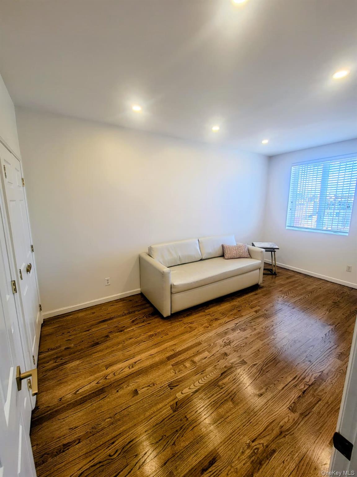 109 Rutledge Street, Unit 7 Brooklyn, NY 11249 - Photo 7 of 9 a view of a room with wooden floor and window