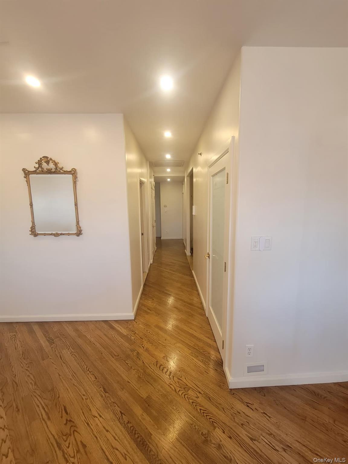 109 Rutledge Street, Unit 7 Brooklyn, NY 11249 - Photo 8 of 9 a view of a hallway with wooden floor