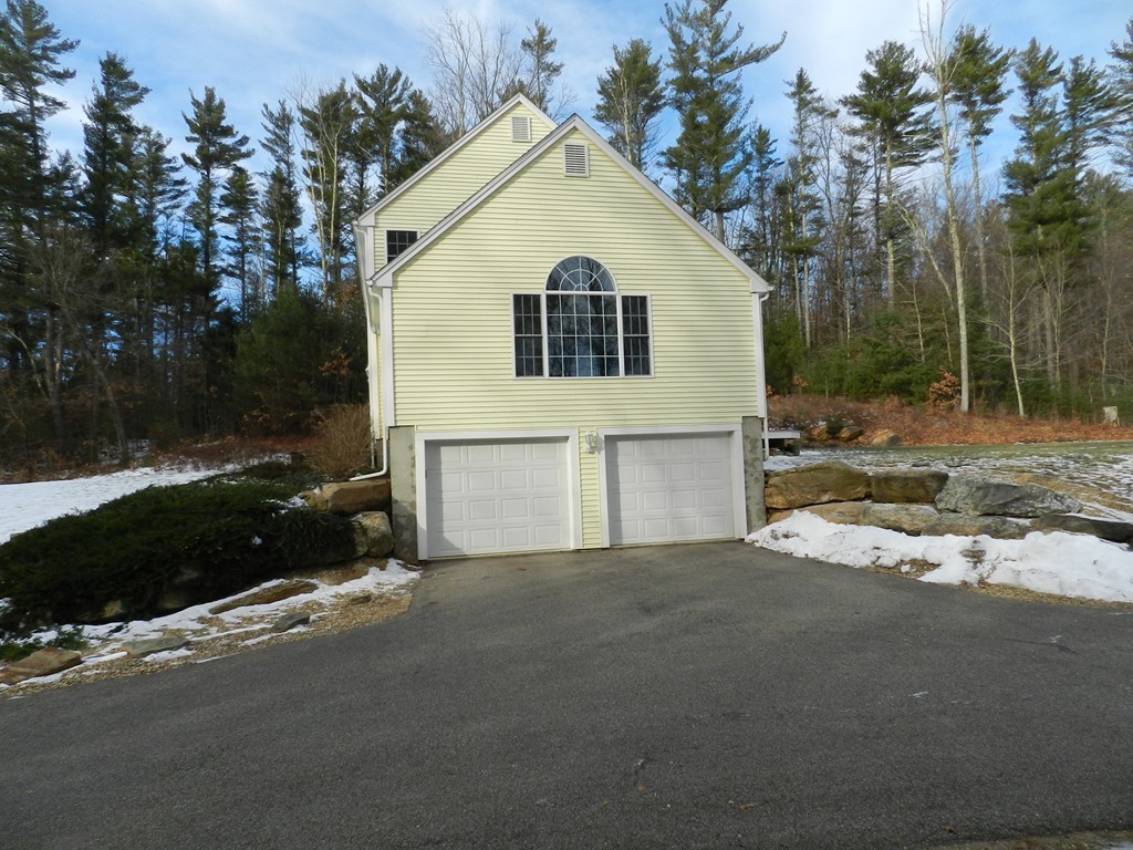 415 Mashapaug Road Holland, MA 01521 - Photo 18 of 26 a view of a white house with a yard and large tree