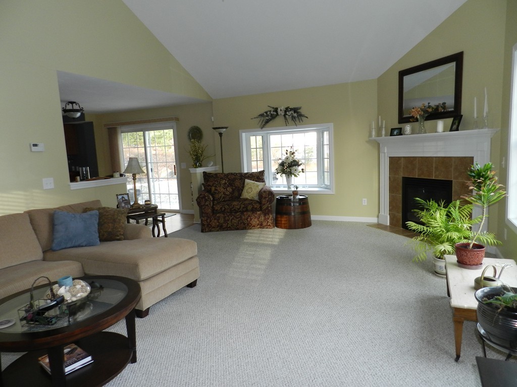 415 Mashapaug Road Holland, MA 01521 - Photo 5 of 26 a living room with furniture and a fireplace