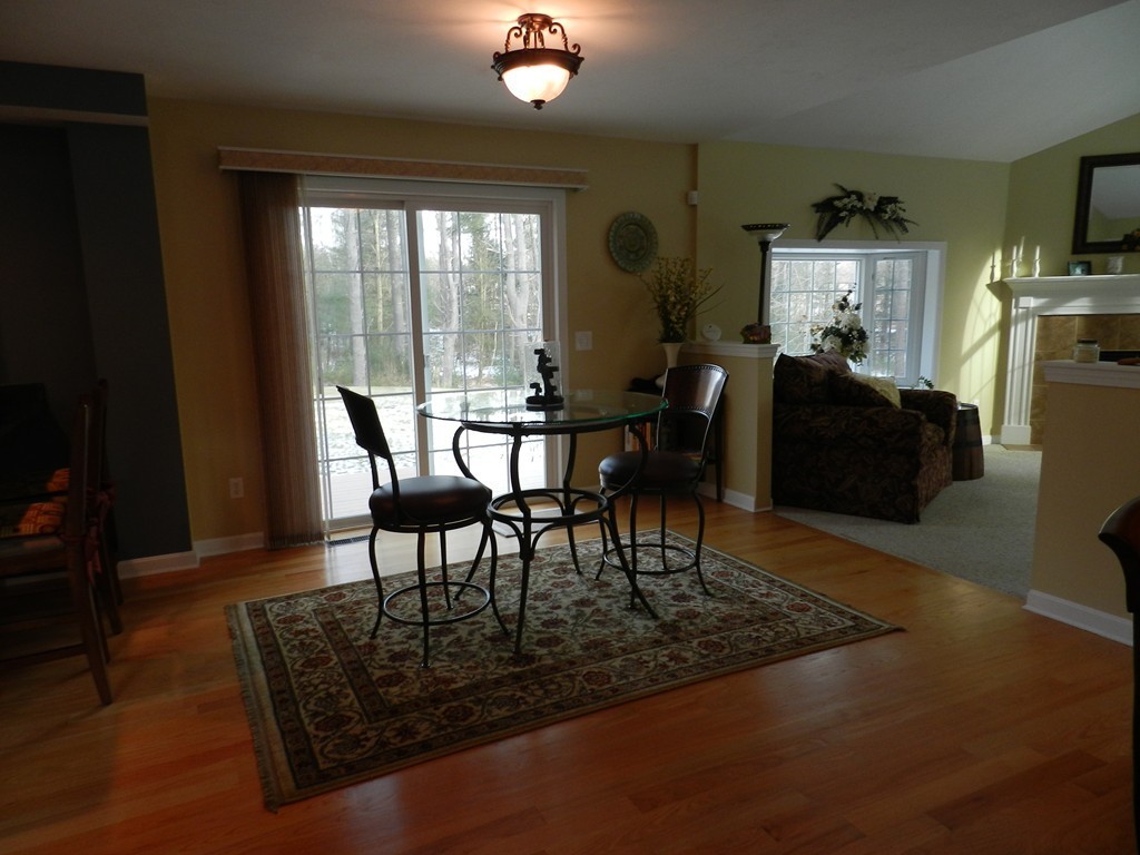 415 Mashapaug Road Holland, MA 01521 - Photo 9 of 26 a view of a dining room with furniture window and wooden floor