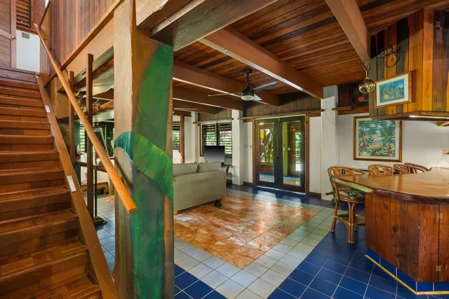 a backyard of a house with barbeque oven table and chairs