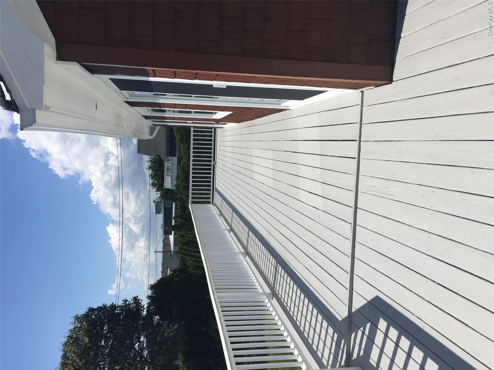 2 South Valley Road Hampton Bays, NY 11946 - Photo 16 of 19 a view of balcony with wooden floor