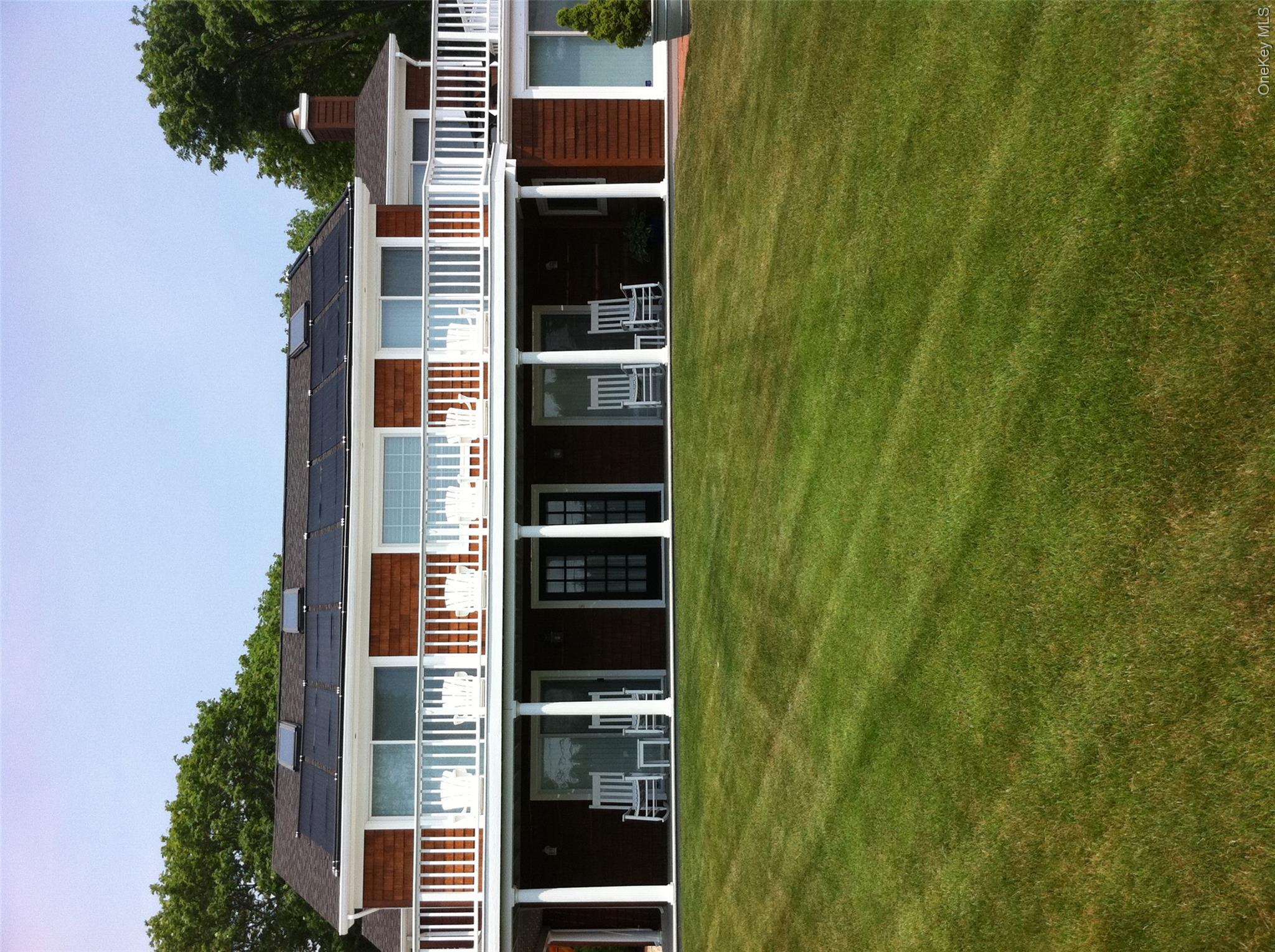 2 South Valley Road Hampton Bays, NY 11946 - Photo 17 of 19 a front view of a building with a garden