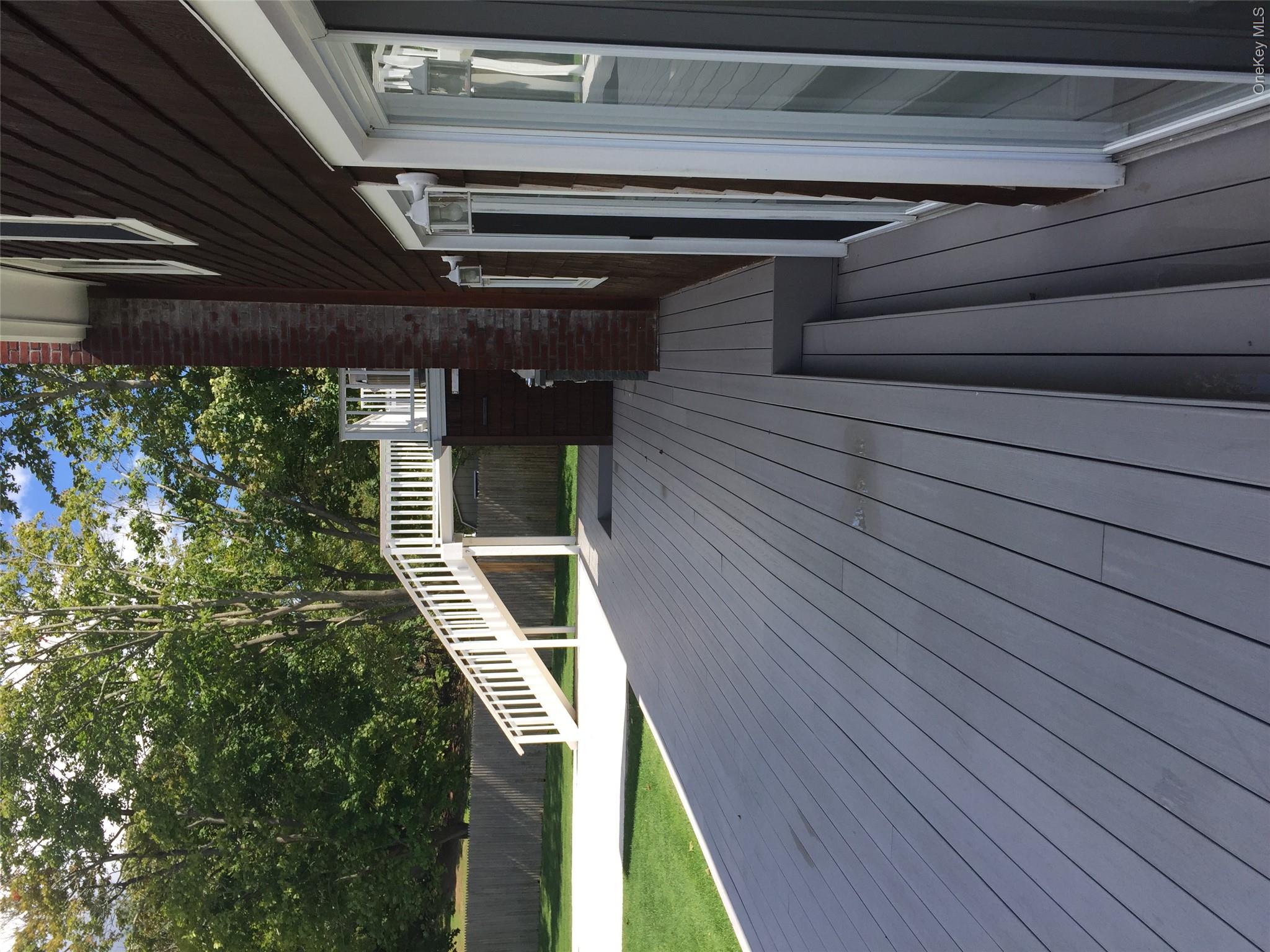2 South Valley Road Hampton Bays, NY 11946 - Photo 19 of 19 a balcony with wooden floor