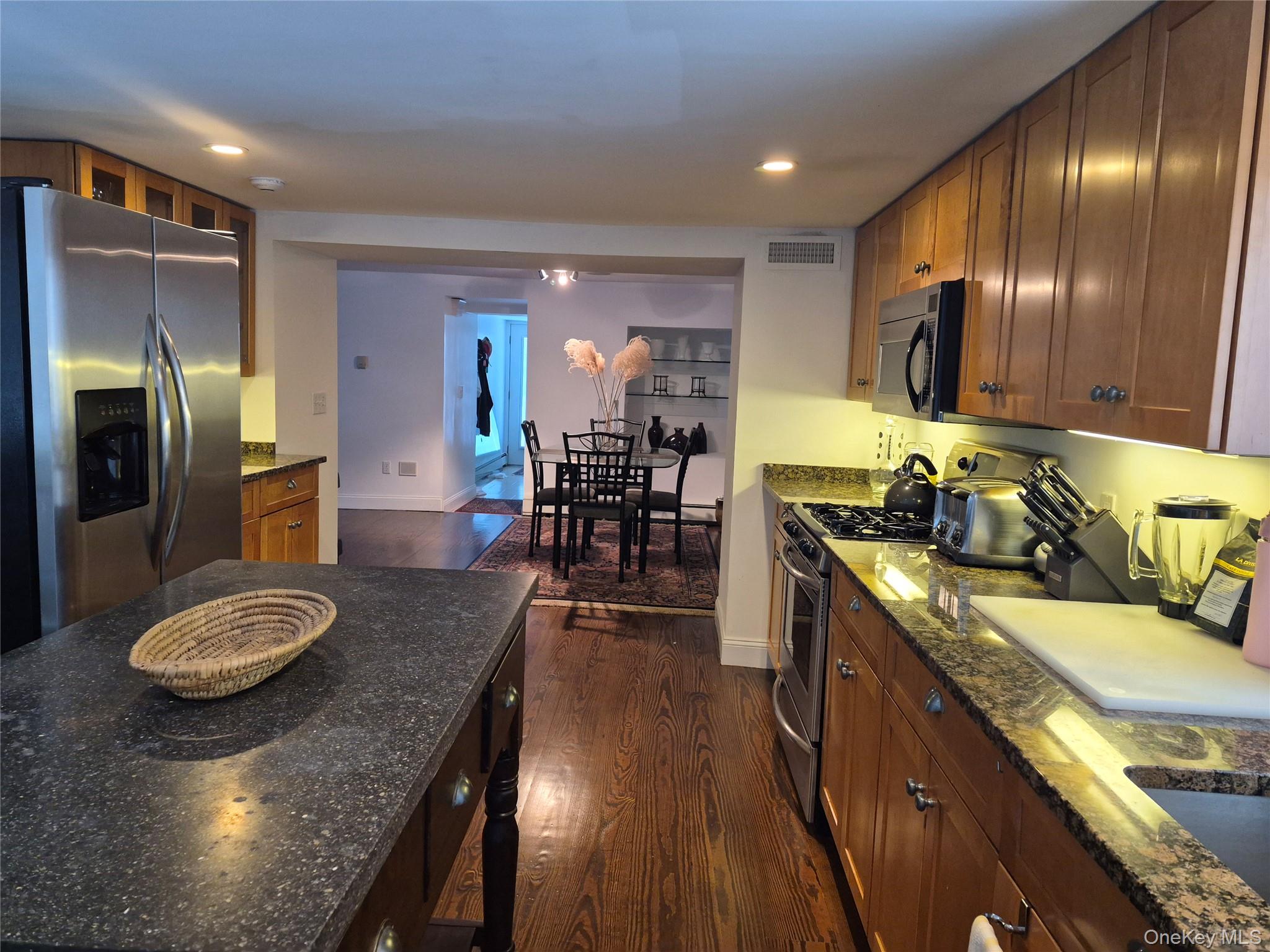2 South Valley Road Hampton Bays, NY 11946 - Photo 7 of 19 a kitchen with stainless steel appliances granite countertop a sink stove and refrigerator