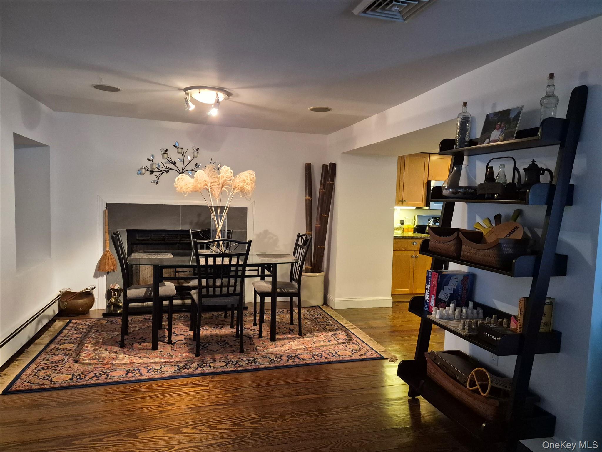 2 South Valley Road Hampton Bays, NY 11946 - Photo 8 of 19 a view of a dining room with furniture and a view of kitchen