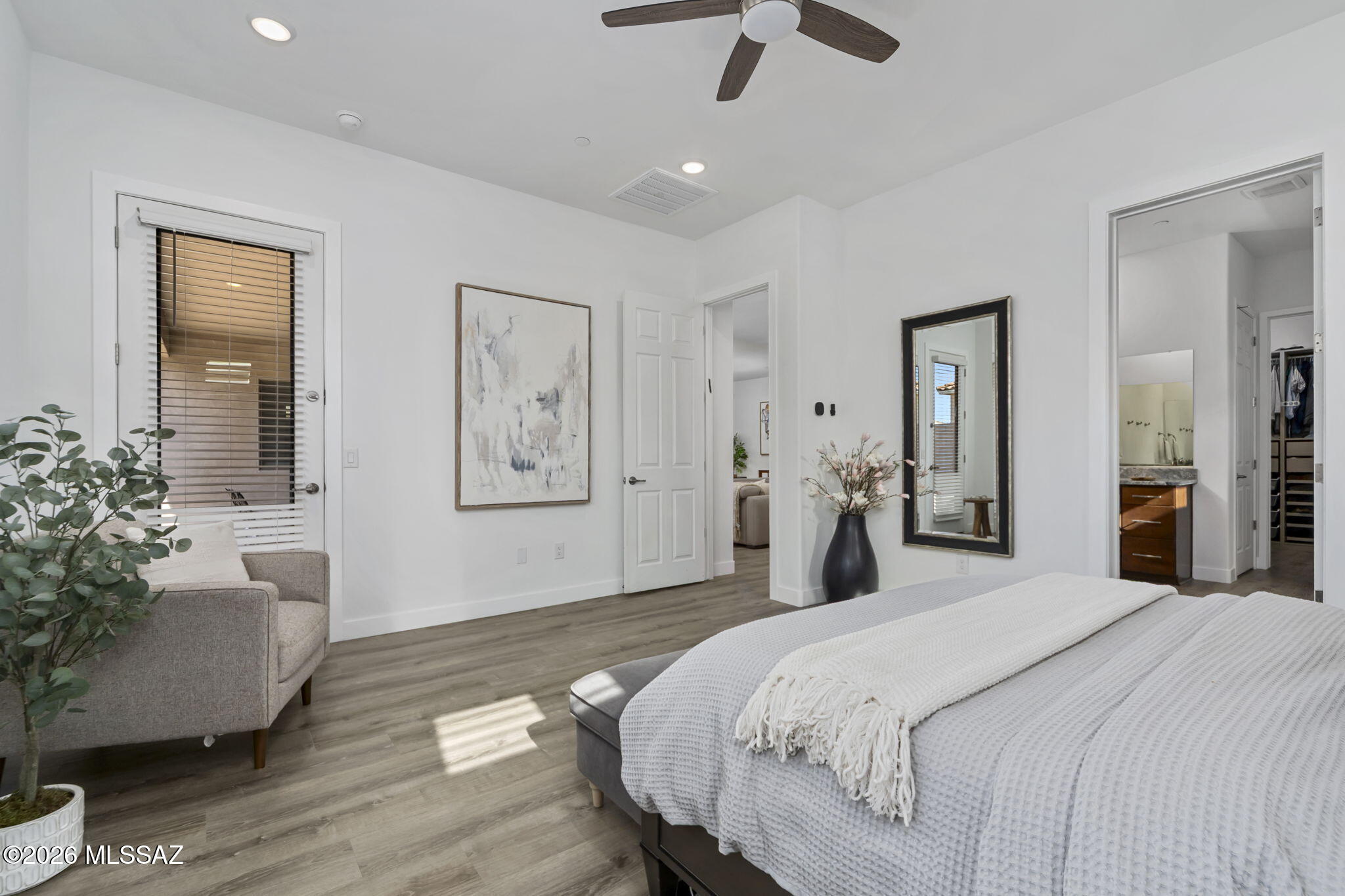 12791 East Tortoise Pointe Drive Vail, AZ 85641 - Photo 24 of 50 a bedroom with a large bed and a chandelier