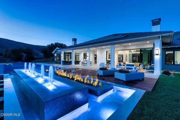 a view of an house with swimming pool and porch