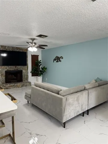 a living room with furniture and a fireplace