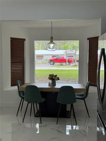 a dining room with furniture and window