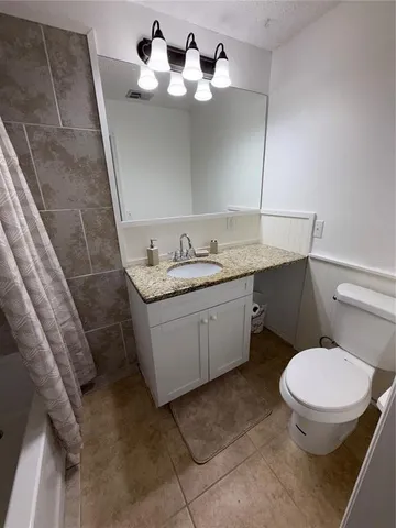 a bathroom with a sink a toilet and mirror
