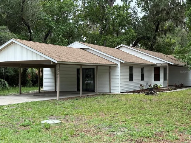 a backyard of a house with garden and patio