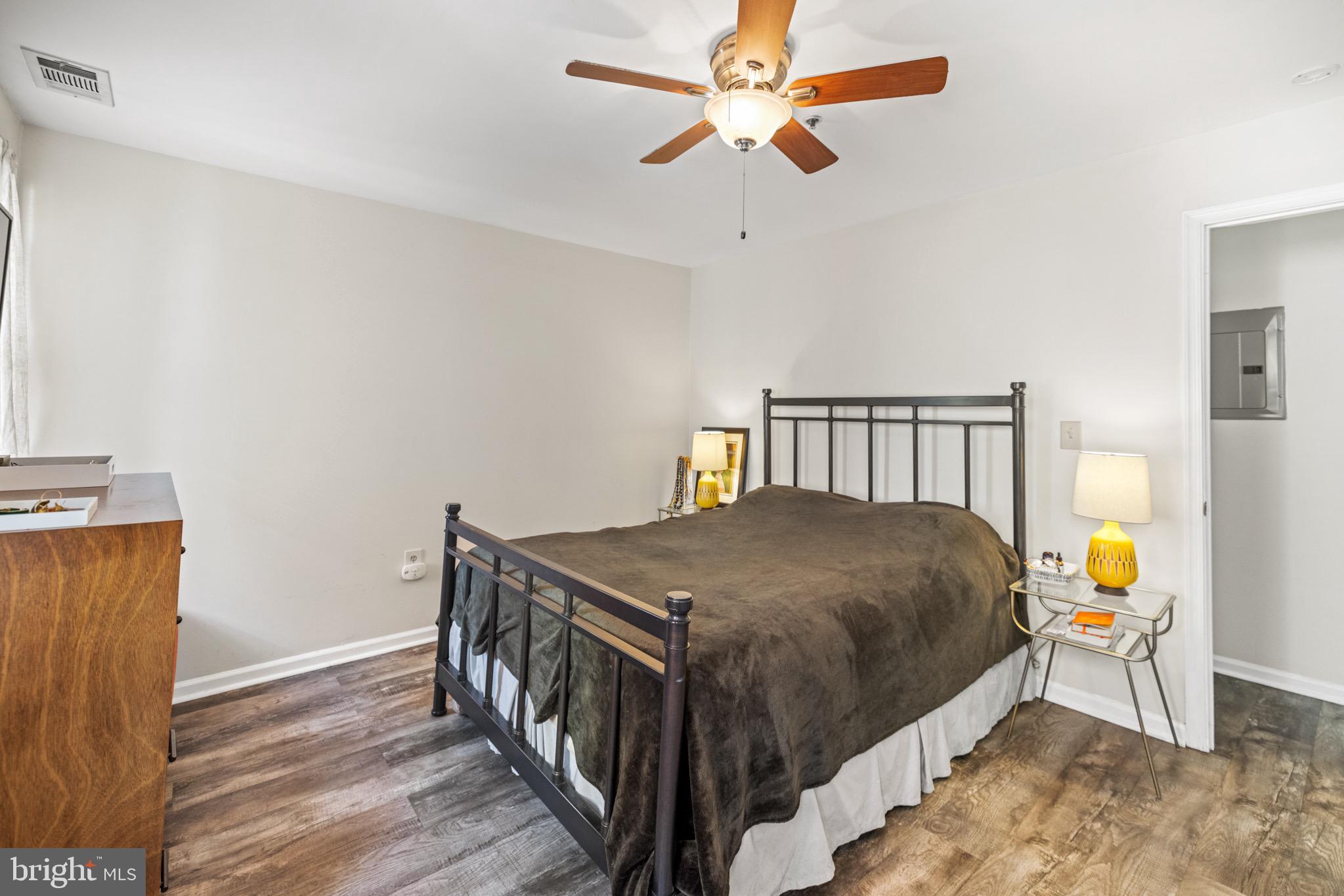 1210 Perry Street Northeast, Unit 201 Washington, DC 20017 - Photo 11 of 16 a bedroom with a bed and a chandelier