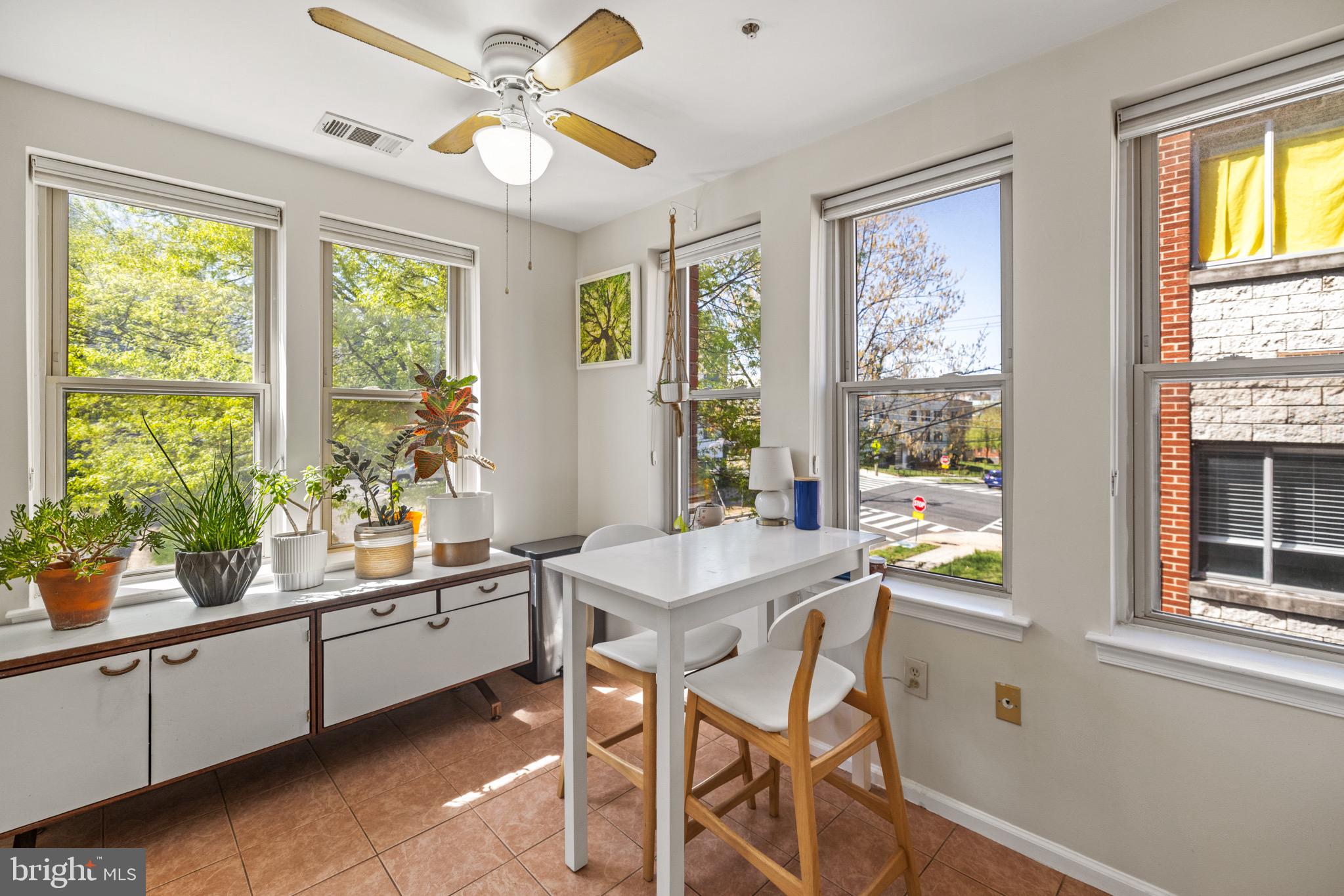 1210 Perry Street Northeast, Unit 201 Washington, DC 20017 - Photo 3 of 16 a view of a dining room with furniture a chandelier and window
