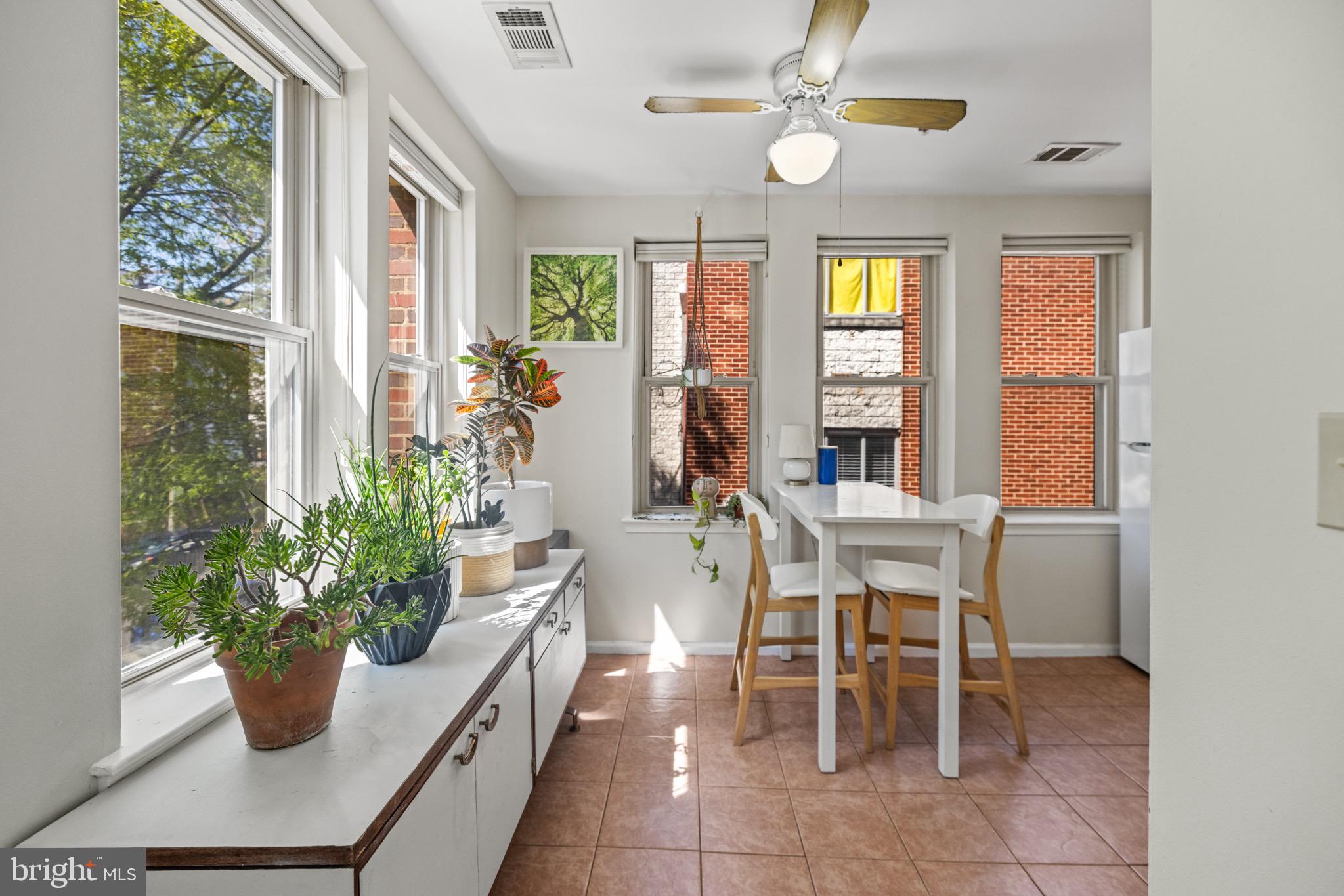 1210 Perry Street Northeast, Unit 201 Washington, DC 20017 - Photo 5 of 16 a view of a dining room with furniture and a potted plant