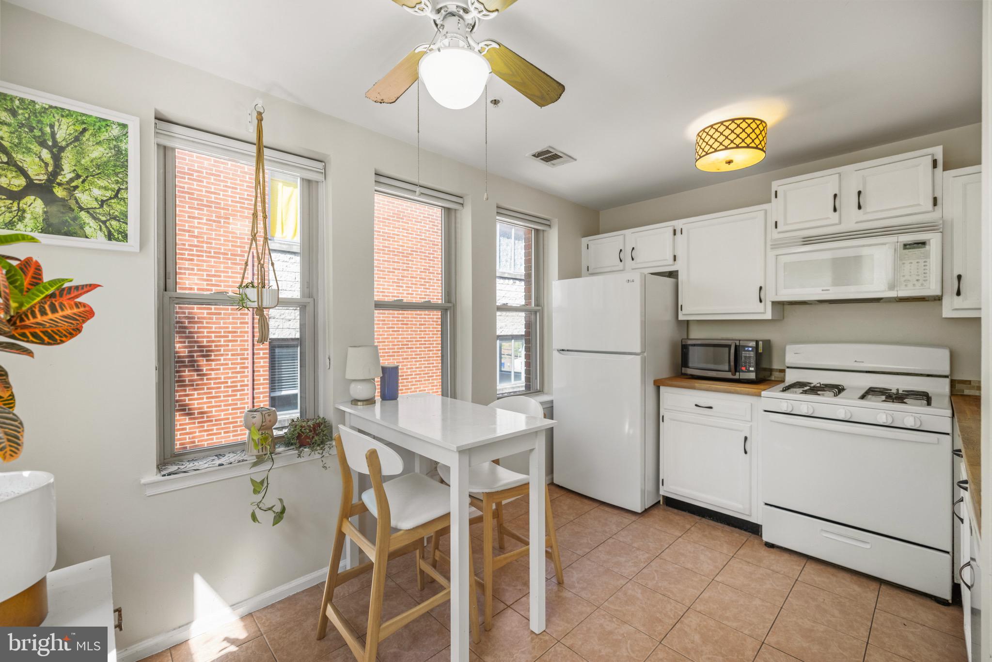 1210 Perry Street Northeast, Unit 201 Washington, DC 20017 - Photo 6 of 16 a kitchen with appliances cabinets and a window